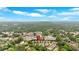 Wide aerial view of the community surrounded by lush green trees under a blue sky at 12 Pine St, Roswell, GA 30075