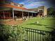 Outdoor space featuring picnic tables under the roofed area with an outdoor play area on the grass at 12 Pine St, Roswell, GA 30075