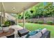 Covered patio and fenced backyard with green grass and retaining wall at 12 Pine St, Roswell, GA 30075