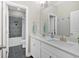 Bathroom with dual sinks and white cabinetry and a tiled shower and bathtub at 12 Pine St, Roswell, GA 30075