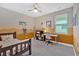Cozy bedroom with carpet, ceiling fan, natural light, and desk at 12 Pine St, Roswell, GA 30075