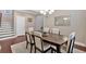 Elegant dining room with a dark wood table, six upholstered chairs, an area rug, and hardwood flooring at 12 Pine St, Roswell, GA 30075