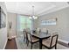 Elegant dining room with a dark wood table, six upholstered chairs, a chandelier, and hardwood flooring at 12 Pine St, Roswell, GA 30075