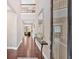 Elegant entryway with hardwood floors, a high ceiling, a decorative mirror, and a view of the living spaces at 12 Pine St, Roswell, GA 30075