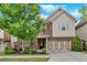 Charming two-story home featuring brick and siding, a well-manicured lawn, and an attached two-car garage at 12 Pine St, Roswell, GA 30075