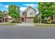 Well-maintained two-story home featuring a brick facade, two-car garage, and landscaped front yard at 12 Pine St, Roswell, GA 30075