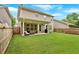 Back exterior of home with covered patio and fenced backyard at 12 Pine St, Roswell, GA 30075