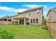 Back exterior of home with covered patio and fenced backyard at 12 Pine St, Roswell, GA 30075