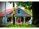 Inviting taphouse with an eye-catching red door, wood facade, and outdoor patio seating at 12 Pine St, Roswell, GA 30075