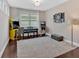 Game room with hardwood floors, natural light, and arcade games at 12 Pine St, Roswell, GA 30075