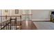 Second-floor hallway with hardwood floors and iron railing at 12 Pine St, Roswell, GA 30075