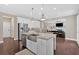 Beautiful kitchen with stainless appliances, island sink, and open access to living area at 12 Pine St, Roswell, GA 30075