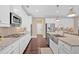 Kitchen with stainless steel appliances, island, and light stone countertops at 12 Pine St, Roswell, GA 30075