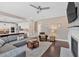 Open-concept living room with a fireplace, hardwood floors, comfortable seating, and views into the kitchen at 12 Pine St, Roswell, GA 30075