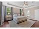 Stylish bedroom with tray ceiling, dark hardwood floors, and a luxurious bed at 12 Pine St, Roswell, GA 30075
