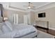 Bedroom featuring tray ceiling, hardwood floors, and a modern dresser at 12 Pine St, Roswell, GA 30075