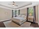 Cozy bedroom featuring a plush bed, tray ceilings, and dark hardwood floors at 12 Pine St, Roswell, GA 30075