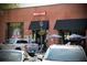 Rock 'N Taco restaurant exterior with a brick facade, outdoor seating, and modern garage-style windows at 12 Pine St, Roswell, GA 30075