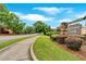 Community sign at The Village on Pine, complemented by green landscaping and a sidewalk at 12 Pine St, Roswell, GA 30075