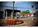 Charming streetscape showcasing local businesses and a well-maintained roundabout with vibrant flowers at 12 Pine St, Roswell, GA 30075