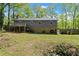 Exterior view of home with a deck and a large grassy backyard perfect for outdoor activities and gatherings at 230 Oakridge Se Dr, Cartersville, GA 30121
