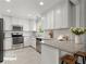 Updated kitchen with white cabinets, stainless steel appliances, granite counters, and tiled backsplash at 230 Oakridge Se Dr, Cartersville, GA 30121