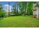 Expansive backyard with lush green lawn, mature trees, and garden, offering privacy and space for outdoor activities at 3047 Hudson Ct, Decatur, GA 30033