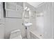 Tiled bathroom features a toilet, sink, shower with white tile, and built-in shelves at 3047 Hudson Ct, Decatur, GA 30033