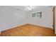 Bedroom featuring hardwood floors, white trim, and window at 3047 Hudson Ct, Decatur, GA 30033