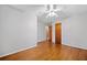 Bedroom features hardwood floors, ceiling fan and leads to hallway at 3047 Hudson Ct, Decatur, GA 30033