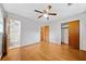 Bedroom with hardwood floors, ceiling fan, and adjacent bathroom with tiled floor at 3047 Hudson Ct, Decatur, GA 30033