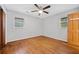An empty bedroom features hardwood floors, ceiling fan, and window with blinds at 3047 Hudson Ct, Decatur, GA 30033
