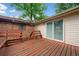 Wooden deck featuring built-in benches and access to the house through sliding glass doors at 3047 Hudson Ct, Decatur, GA 30033