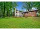 A charming home with a brick and siding exterior, a large backyard, and a deck for outdoor enjoyment at 3047 Hudson Ct, Decatur, GA 30033