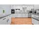 Bright kitchen with white cabinets, granite counters, stainless appliances, and hardwood floors at 3047 Hudson Ct, Decatur, GA 30033