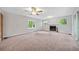 Open living room with a fireplace, ceiling fan, and natural light at 3047 Hudson Ct, Decatur, GA 30033