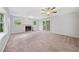 Spacious living room featuring a fireplace, ceiling fan, and access to the backyard at 3047 Hudson Ct, Decatur, GA 30033