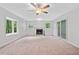 Inviting living room with large windows, a ceiling fan, and cozy fireplace at 3047 Hudson Ct, Decatur, GA 30033