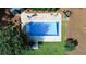 Aerial view of a beautiful covered pool surrounded by manicured lawns and mature trees at 3140 Thoreau Ct, Loganville, GA 30052