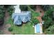Aerial view of a private home and a sparkling blue swimming pool surrounded by lush greenery at 3140 Thoreau Ct, Loganville, GA 30052