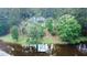 Secluded home on wooded lot with private lake access and a charming dock at 3140 Thoreau Ct, Loganville, GA 30052