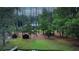 Aerial view of a serene, wooded property with a hidden house and a charming dock at 3140 Thoreau Ct, Loganville, GA 30052