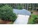 Aerial view of a home with a three-car garage, long driveway, and green lawn at 3140 Thoreau Ct, Loganville, GA 30052