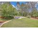 Expansive backyard with well-maintained lawn and in-ground pool featuring a lounge area at 3140 Thoreau Ct, Loganville, GA 30052