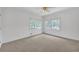 Neutral bedroom featuring soft carpet, white trim, two windows, and ceiling fan with decorative lighting at 3140 Thoreau Ct, Loganville, GA 30052