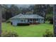 Charming home exterior with a well-manicured lawn and mature trees, creating a serene setting at 3140 Thoreau Ct, Loganville, GA 30052