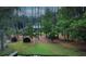 Scenic view of a home nestled among tall trees, offering privacy and a connection with nature at 3140 Thoreau Ct, Loganville, GA 30052