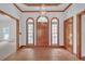 Elegant foyer with hardwood floors and a decorative light fixture at 3140 Thoreau Ct, Loganville, GA 30052