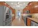 Spacious kitchen featuring stainless steel appliances and wooden cabinetry at 3140 Thoreau Ct, Loganville, GA 30052