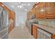 An open kitchen featuring stainless steel appliances and wooden cabinetry at 3140 Thoreau Ct, Loganville, GA 30052